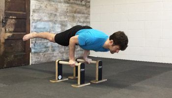 Practicing a Bodyweight Arm Lever on Parallettes